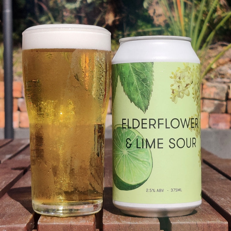 This is a photo of a green can of beer that has been made by Ocho and it is called Elderflower Lime & Sour. It has been poured out into a glass so you can see the amber colour of the beer.